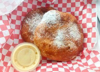 Utah scone | Eat Your World A classic Utah scone, deep-fried dough dusted in sugar, with a side of honey butter.