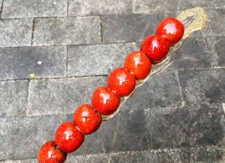 Tanghulu – Beijing, China | Eat Your World Tanghulu, sugared red hawthorn berries, on a stick from a street in Beijing.