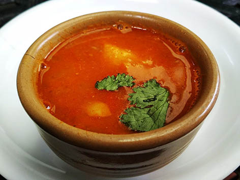 Aloo tama, a potato and bamboo shoots soup in Nepali cuisine, served in a bowl in Kathmandu