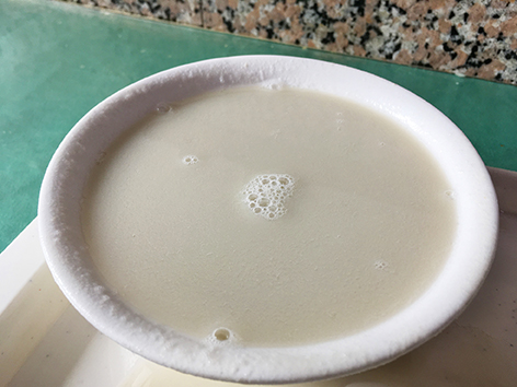 A steaming hot bowl of douzhi, a fermented mung-bean drink in Beijing, China.