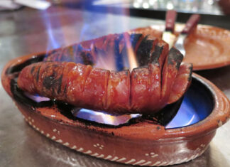 Chourico assado – Lisbon, Portugal Flaming chourico assado in a traditional clay bowl from a Lisbon fado bar.
