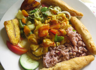 Curried lobster – Jamaica | Eat Your World A plate of curried lobster with rice and peas, plantains, and festival on Winnifred Beach in Portland, Jamaica