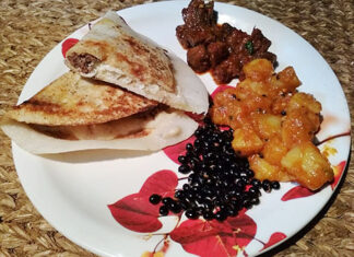 Chatamari in Kathmandu, Nepal | Eat Your World A plate of chatamari, Nepali crepe, with some sides of beans, potatoes, and meat from Kathmandu.