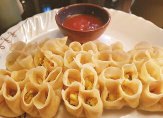 Open momo – Kathmandu, Nepal Open, or unclosed, momo dumplins with dipping sauce in Kathmandu, Nepal.