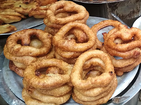 Stacks of fried rice doughnuts, called sel roti, from Kathmandu, Nepal.