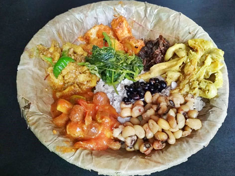A dish of Nepali samay baji, a mix of beaten rice, meat, pickle, greens, and more, from Kathmandu.